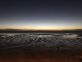 Scenic view of beach against sky during sunset