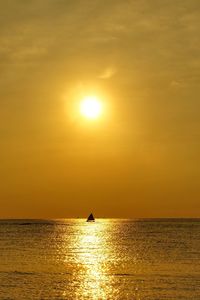 Scenic view of sea against orange sky