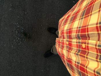 Low section of man standing on street