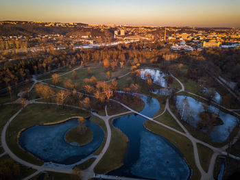 High angle view of river amidst cityscape against sky