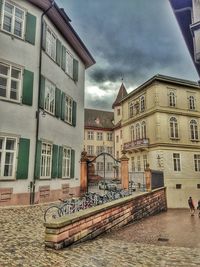 Buildings in city against cloudy sky