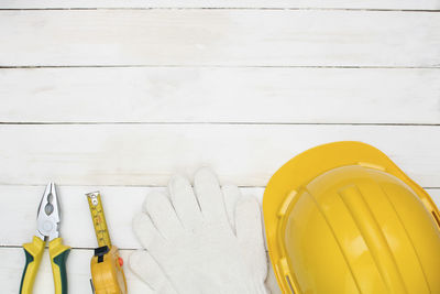 Close-up of work tools and hardhat on table