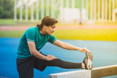 Young man exercising at stadium