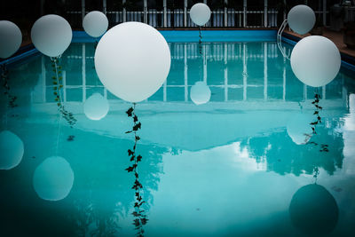 Reflection of balloons on swimming pool