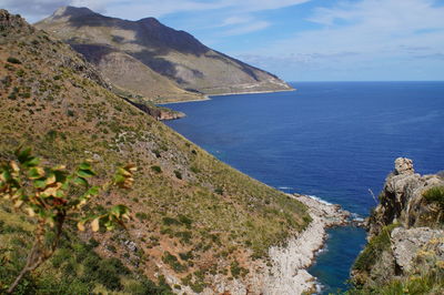 Scenic view of sea and mountains against sky