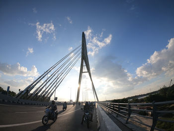 View of bridge over road in city against sky