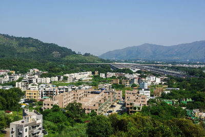 High angle view of townscape and mountains against clear sky