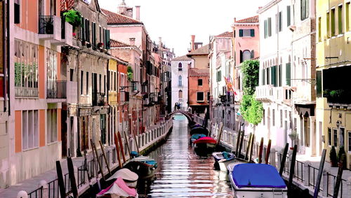 Canal amidst buildings in city