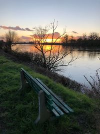 Scenic view of lake against sky at sunset