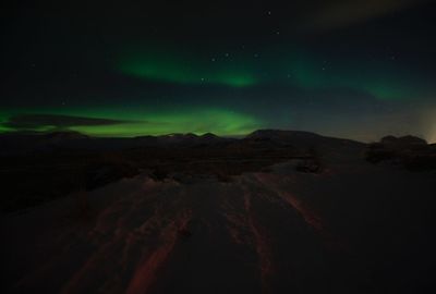 Scenic view of landscape against sky at night