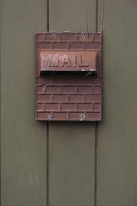 Rusty mailbox on wall