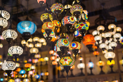 Low angle view of illuminated lanterns hanging at market stall