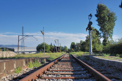 Railroad track amidst trees against sky