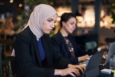 Businesswoman using digital tablet in cafe