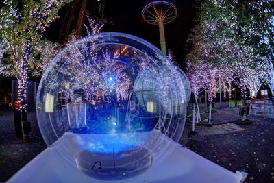 Illuminated ferris wheel at night