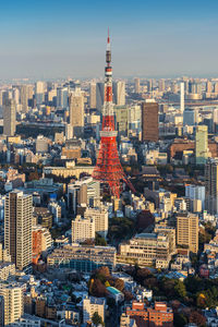 Tokyo tower against sky in city