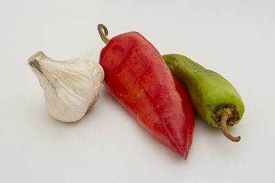 High angle view of chili peppers on white background