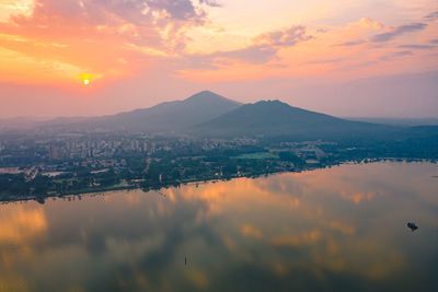 Scenic view of cityscape against sky during sunset