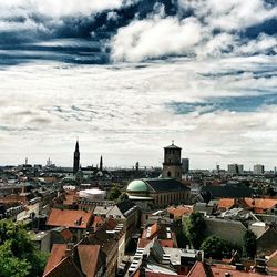 Cityscape against cloudy sky