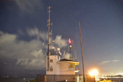 Low angle view of illuminated buildings against sky at night