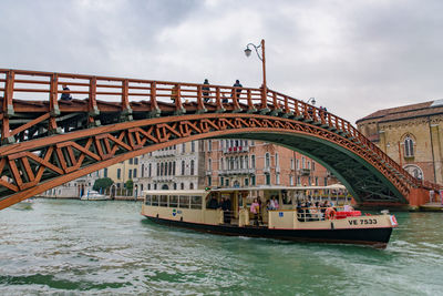 Arch bridge over river against sky