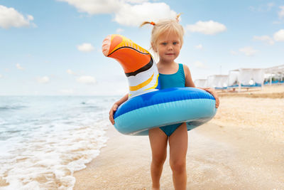 Girl with swimming tube at beach