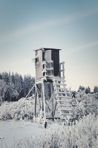 Traditional windmill on field against sky