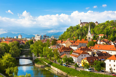 River amidst buildings in town against sky