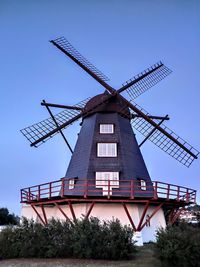 Low angle view of traditional windmill against sky