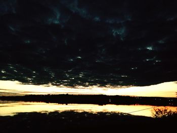 Scenic view of silhouette trees against sky at sunset