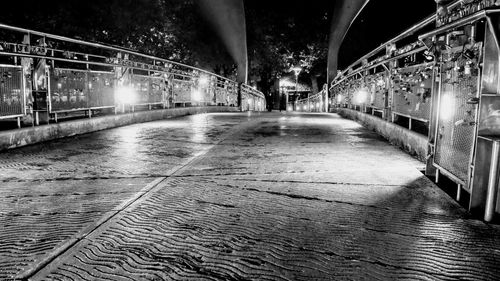 Illuminated bridge over water in city at night