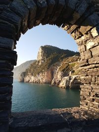 Rock formations by sea against sky