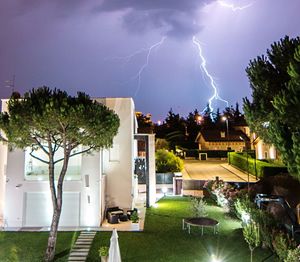 Panoramic view of trees and houses against sky