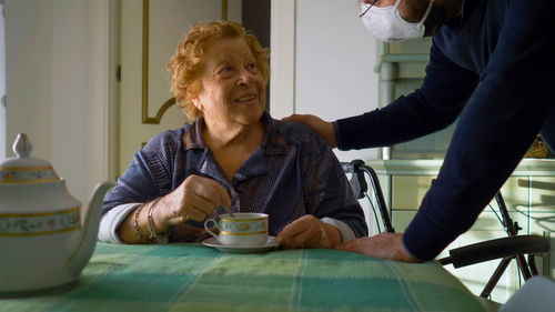 Woman sitting on table at home