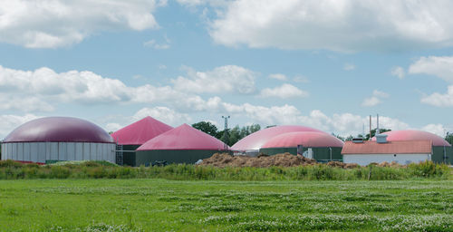 Houses on field against sky