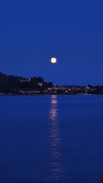 Scenic view of sea against clear sky at night