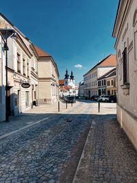 Street amidst buildings against sky in city