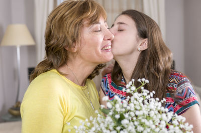 Close-up of girl kissing mother