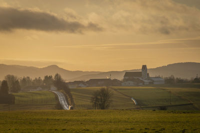 Scenic view of field against sky during sunset