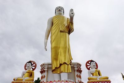 Low angle view of statue against temple against sky