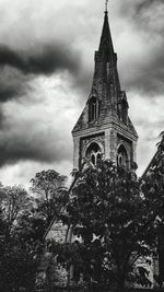 Low angle view of church against cloudy sky