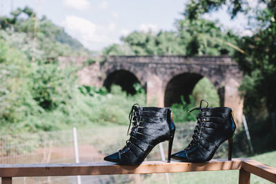 Close-up of shoes on stone wall