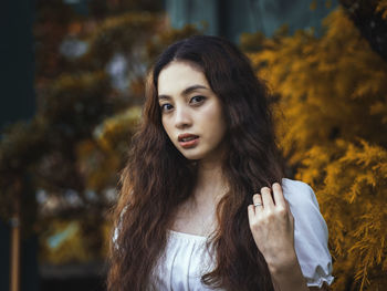 Portrait of young woman standing outdoors