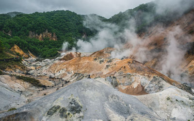 Smoke emitting from volcanic mountain