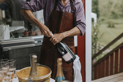 Man opening champagne bottle