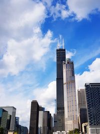 Low angle view of buildings against cloudy sky