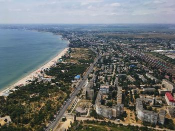 High angle view of buildings and sea against sky