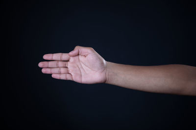Close-up of hands over black background