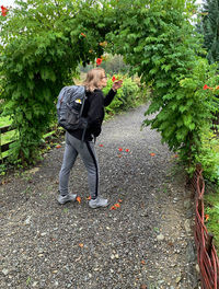 Women smelling flowers on an flower arch