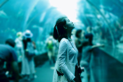 Portrait of young woman in aquarium